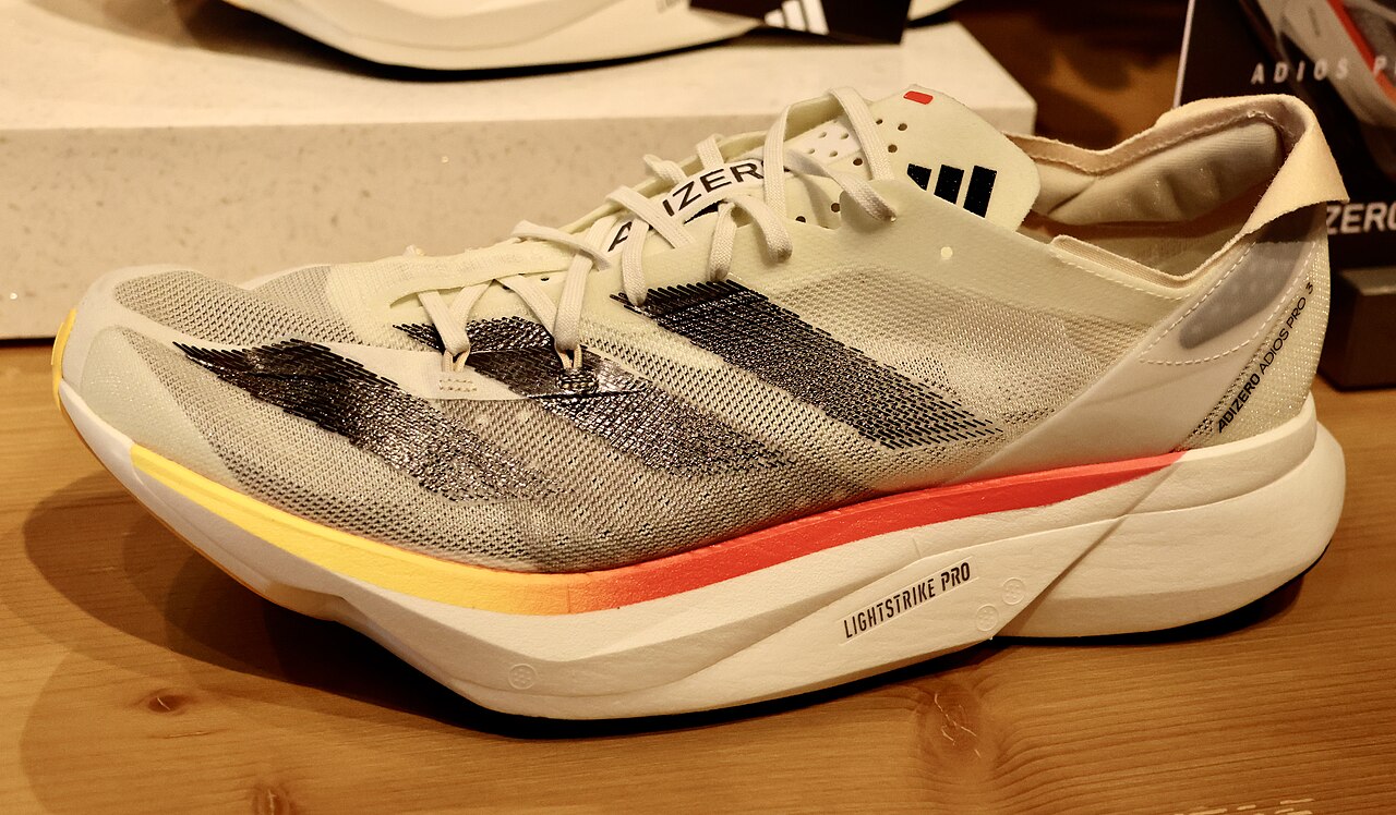 An Adidas Adizero Adios Pro 3 racing shoe, showing the tall stack of foam under the foot
